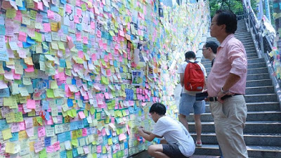 When walls talk: Hong Kong protesters bring grievances to suburbs